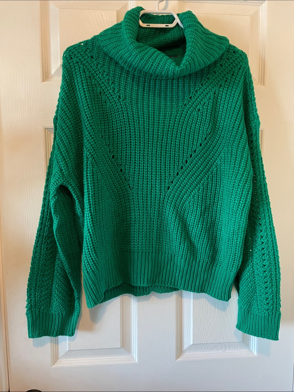 Kelly green turtleneck sweater with crisscross back cutout
